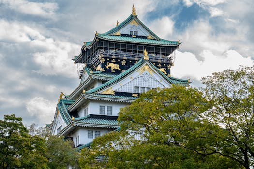 Explore the architectural beauty of Osaka Castle surrounded by lush greenery.
