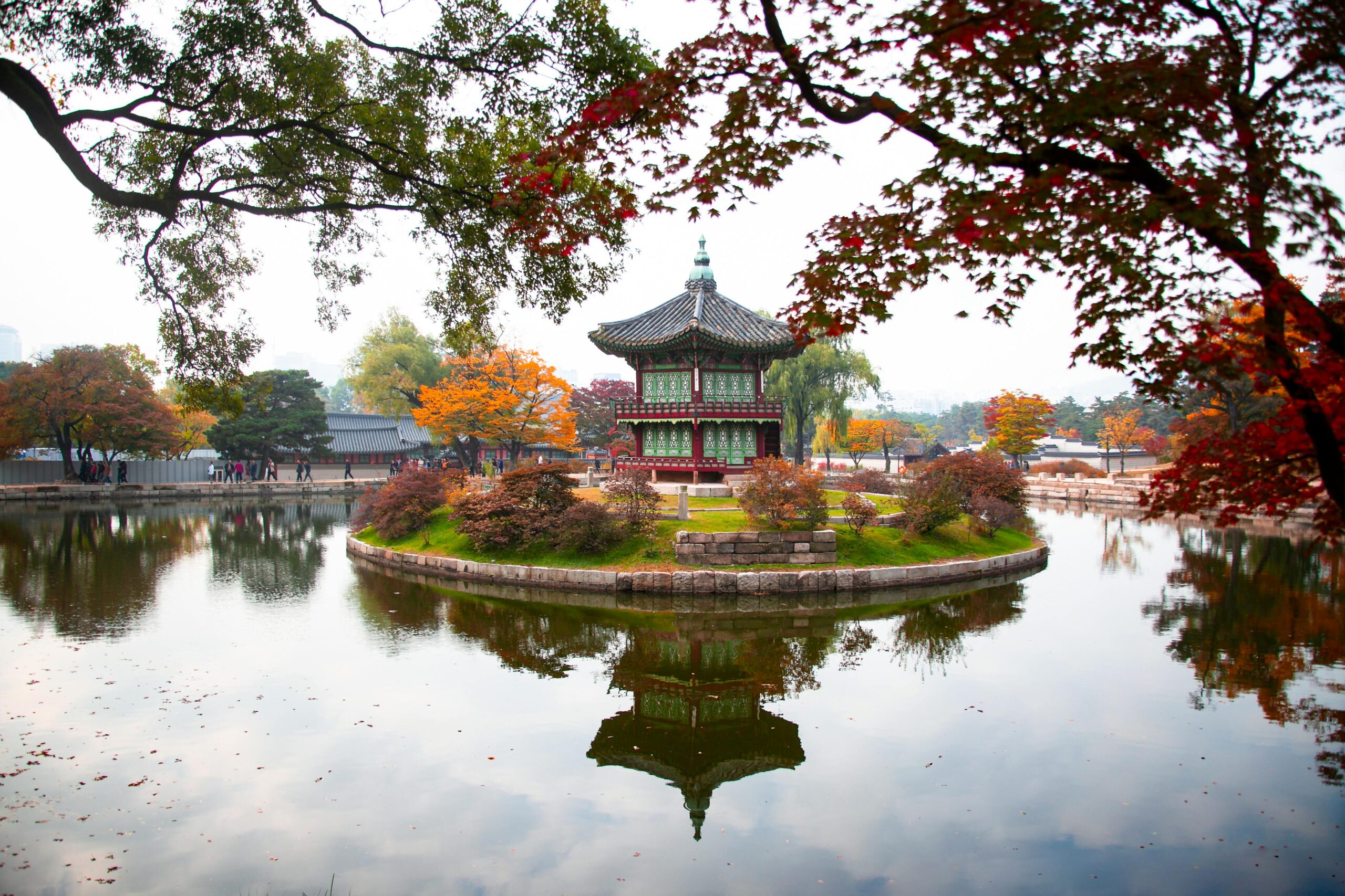 Capture the tranquil beauty of Hyangwonjeong Pavilion surrounded by vivid autumn foliage in Seoul.